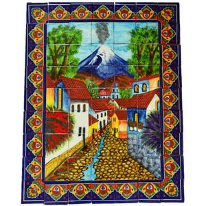 May include: A vibrant tile mural depicting a village scene with a volcano, trees, and colorful buildings. The artwork features a cobblestone street, a flowing stream, and a decorative border with floral and geometric patterns. The tiles are arranged in a rectangular format.