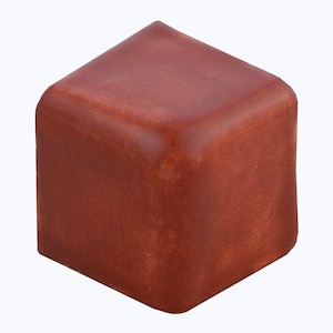 May include: A terracotta-colored ceramic corner tile with a smooth, slightly glossy finish.