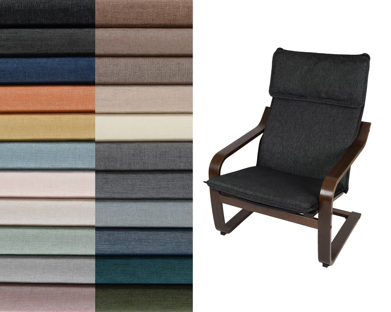 May include: A dark gray armchair with wooden legs and a curved back. The chair is upholstered in a textured fabric. The chair is shown against a white background.