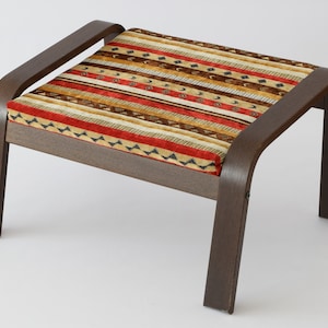 May include: A brown wooden ottoman with a red, brown, and beige patterned cushion. The ottoman has a curved design on the sides and legs.