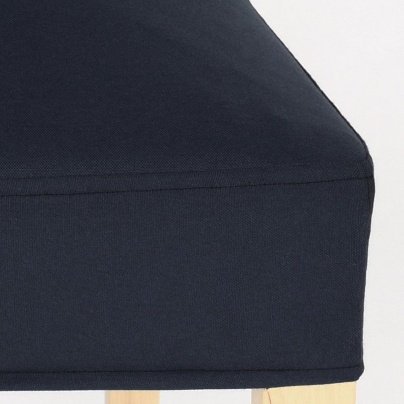 May include: A dark blue chair cushion with a simple design. The cushion is made of a soft, textured fabric and has a clean, finished edge.