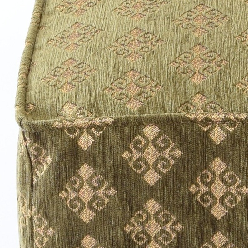 May include: A green fabric ottoman with a diamond pattern in a lighter shade of green. The ottoman has a tufted top and a square shape.