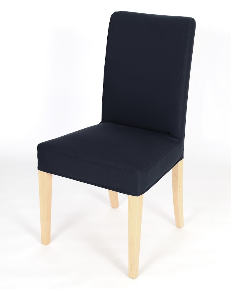 May include: A dark blue dining chair with a wooden frame. The chair has a simple design and is upholstered in a dark blue fabric.