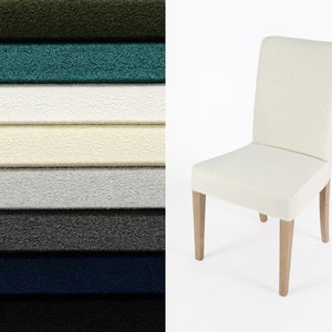 May include: A cream-coloured dining chair with light wood legs is set against a white backdrop. To the left, a stack of fabric swatches in various colours: green, teal, white, cream, grey, charcoal, navy, and black.