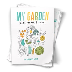 Op de afbeelding: Een witte planner en een dagboek met de titel "My Garden" in kleurrijke tekst. De omslag heeft een cirkel van met de hand getekende groenten en kruiden, waaronder tomaten, uien, wortelen en aubergines. De tekst "The Beginner's Garden" staat onderaan.