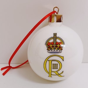 May include: White Christmas bauble with a gold crown and the letters "C R III" in gold.
