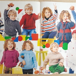 Puede incluir: Una página de revista con prendas de punto para niños. La página muestra a varios niños con coloridos suéteres, cárdigans y un poncho. Las prendas son en tonos de azul, rojo, gris y blanco. El texto de la imagen está en ruso.