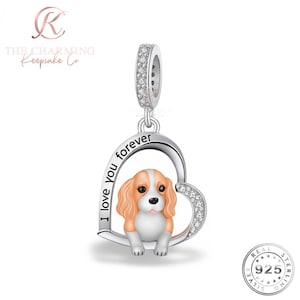 Könnte beinhalten: Silberner Charm-Anhänger mit einem Cavalier King Charles Spaniel-Hund in einem Herz. Das Herz trägt die Aufschrift "I love you forever" und ist mit klaren Kristallen besetzt. Der Charm ist mit "925 Sterling" gekennzeichnet.