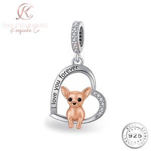 May include: A silver charm with a heart-shaped design, featuring a small, tan Chihuahua inside. The charm has the words "I love you forever" and is accented with clear crystals. The charm is marked "925" for sterling silver.
