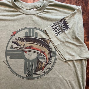 May include: A green t-shirt with a graphic of a fish jumping out of the water. The fish is surrounded by a circle with a stylized design. The text "VERSE" is on the sleeve of the shirt.