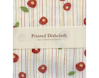 Könnte beinhalten: Ein weißer Geschirrtuch mit roten Kamelienblüten und dünnen roten, gelben und grünen Streifen. Das Geschirrtuch trägt den Text "Printed Dishcloth" und "Japanese traditional print technology" auf einem weißen Etikett.