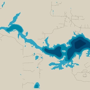 May include: A bathymetric map print featuring a lake with varying shades of blue to indicate depth, set against a light beige background. The map includes thin black lines representing surrounding roads and a compass rose in the top left corner.