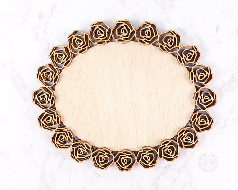 May include: A wooden tray with a decorative rose border. The tray is light brown and has a smooth surface.