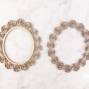 May include: Two wooden frames in the shape of a wreath of roses. The frames are unfinished and ready to be painted or stained.