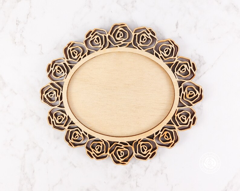 May include: A wooden round frame with a decorative rose design. The frame is made of light wood and has a natural finish.