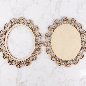 May include: Two unfinished wooden oval frames with a decorative rose design. The frames are made of wood and have a natural finish.