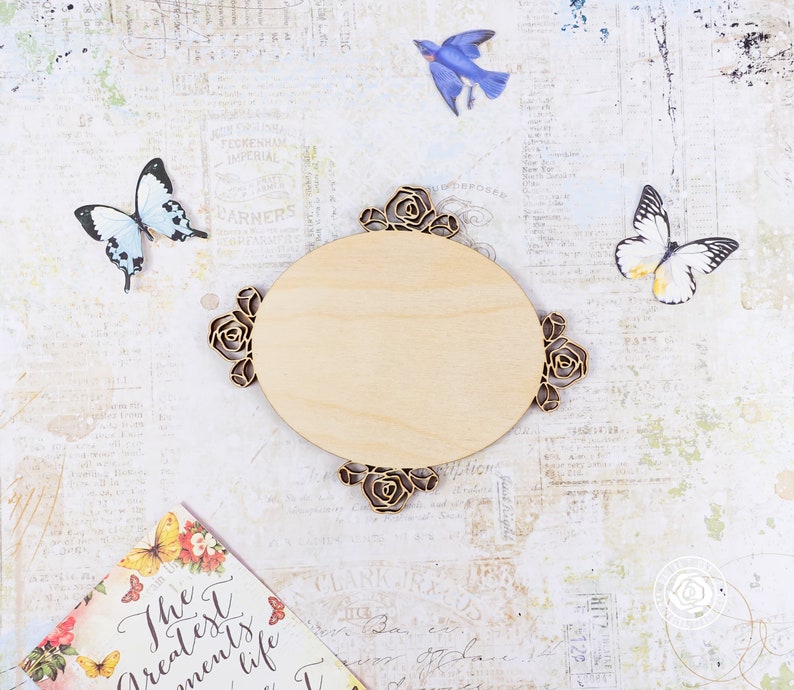 May include: A wooden oval-shaped sign with a decorative floral design. The sign is blank and ready to be personalized.