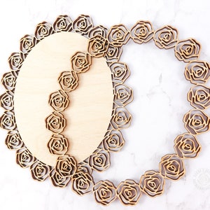 May include: Two wooden oval-shaped plaques with a decorative rose pattern. The plaques are layered on top of each other, creating a three-dimensional effect.