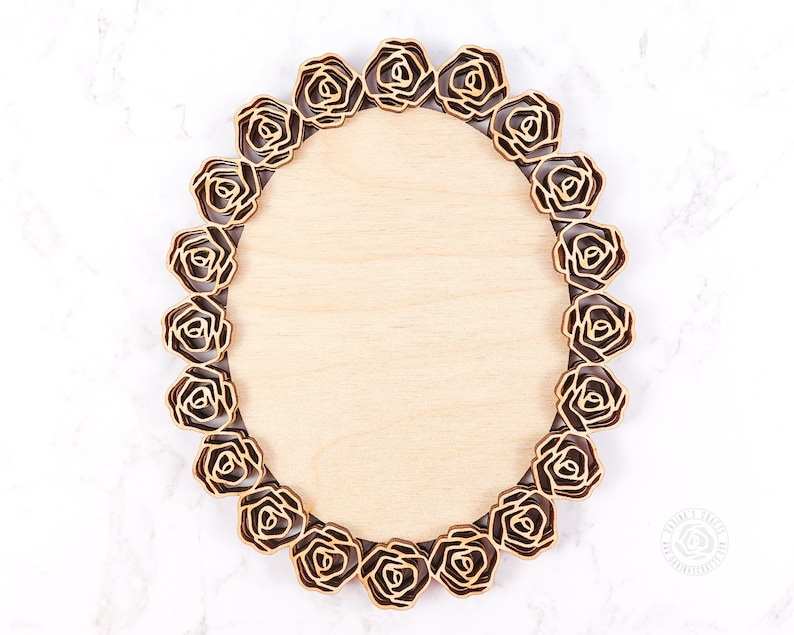May include: An oval wooden frame with a decorative border of laser-cut roses. The frame is made of light wood and has a natural finish.