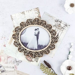 May include: A wooden picture frame with a rose design. The frame is holding a black and white photograph of a couple.