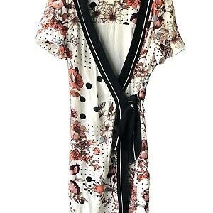 May include: A white wrap dress with a black trim and a floral print. The dress has a tie at the waist and a polka dot pattern.