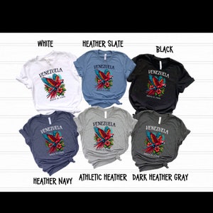 May include: Six t-shirts in different colors featuring a parrot with the text "Venezuela Hasta El Final". The shirts are white, heather slate, black, heather navy, athletic heather, and dark heather gray.