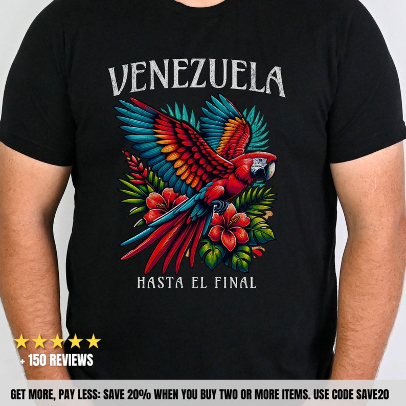 May include: Black t-shirt with a red, yellow, blue, and green parrot flying over tropical flowers and leaves. The text "VENEZUELA" is above the parrot and the text "HASTA EL FINAL" is below the parrot.