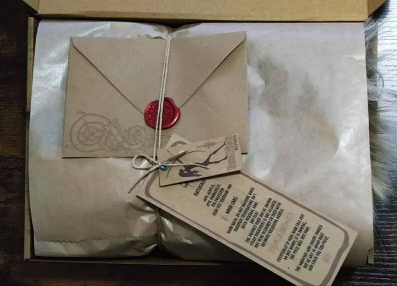 May include: A brown paper package tied with twine and sealed with a red wax stamp. The package includes a small envelope and a tag with the text "MATERIAL 2PINOK MASH CARE STEAR TREATMENT KUND BTWRITESAL THE MORONES AND CARS SHO AS THE FORECL SESAS".