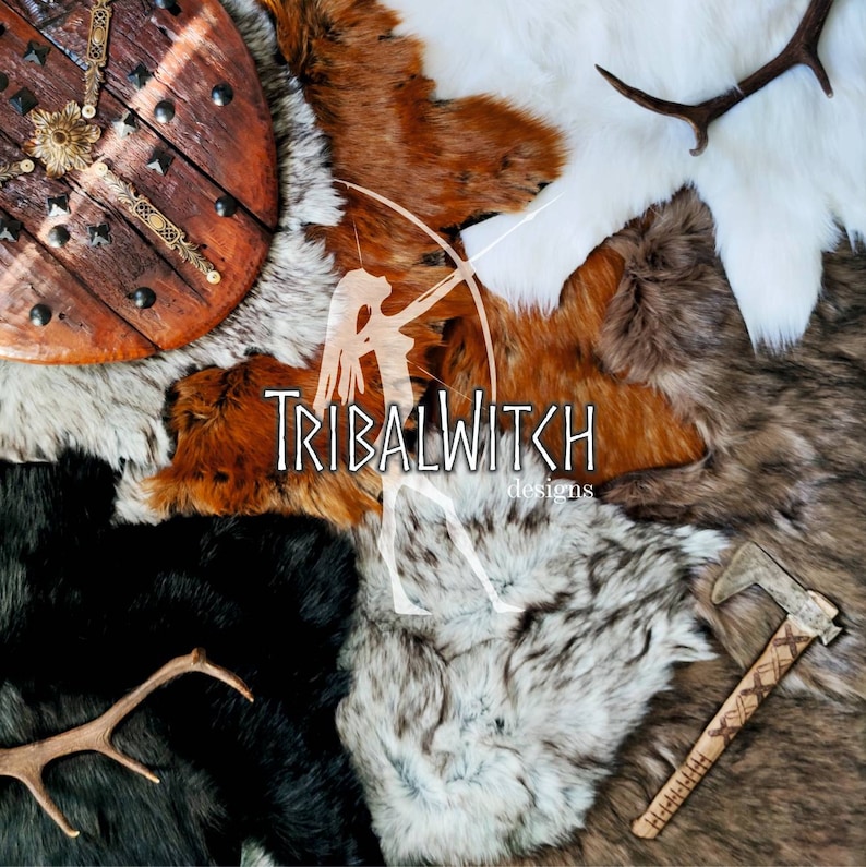 May include: A collection of faux fur hides in various colors and textures, including white, brown, and black. A wooden shield with metal accents and a small axe are also included. The text "TribalWitch designs" is visible in the center of the image.