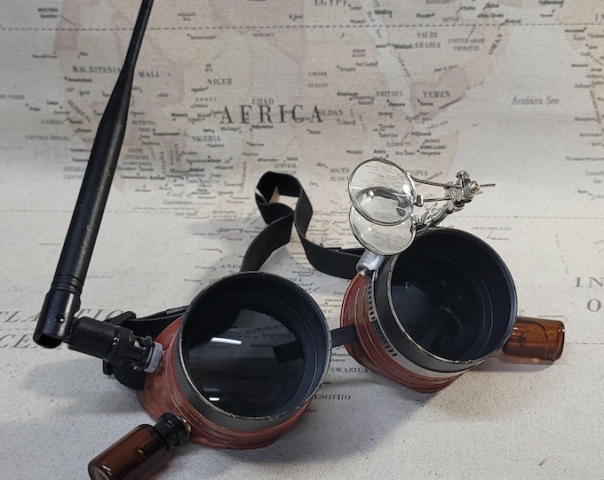 Aged Red/Gold Steampunk Engineer Goggles With a Large Magnifying Loupe and a Vacuum Tube
