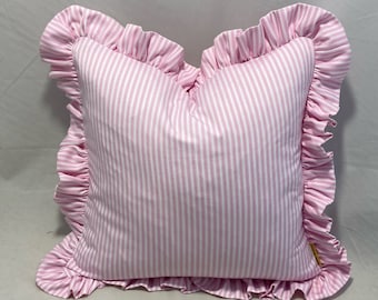 Dusty pink and white woven ticking fabric cushion covers with frill around them