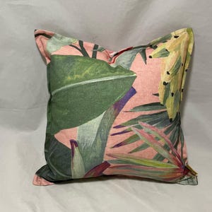 Linen printed tropical jungle motifs in coral with palm leaves, flanged cushions