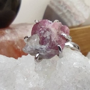 Raw natural pink tourmaline set in 925 sterling silver ring in 6 claws.