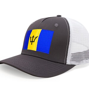 May include: A gray trucker hat featuring the Barbados flag on the front. The flag is a blue rectangle with a yellow stripe and a trident symbol. The hat has a white mesh back and a curved brim.