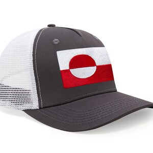 May include: A gray baseball cap with a white mesh back and a curved brim. The cap features an embroidered patch of the Greenlandic flag, with a red and white design. The cap is a trucker style.