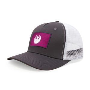 May include: A gray baseball cap with a white mesh back and a curved brim. The cap features a rectangular patch with a white phoenix emblem on a magenta background.