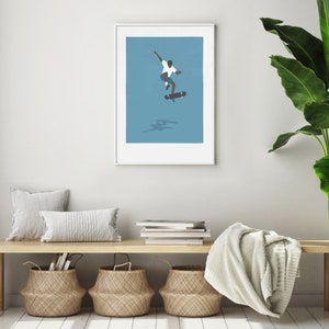 May include: A framed illustration of a person skateboarding on a blue background. The person is wearing a white shirt and blue shorts. The skateboard is black with white wheels.