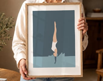 May include: A framed art print featuring a minimalist illustration of a person diving into water. The figure is depicted in a white swimsuit against a backdrop of blue and teal hues. The artwork is encased in a light brown wooden frame.