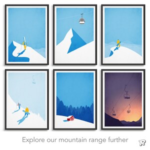 May include: Six framed art prints with minimalist mountain scenes in blue and white. Each print shows skiers, snowboarders, ski lifts, and mountain peaks. The text "Explore our mountain range further" is at the bottom.