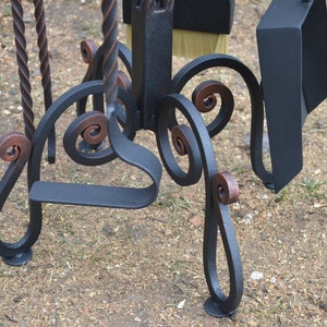 Wrought iron fireplace set. Wrought iron poker and scoop on a stand