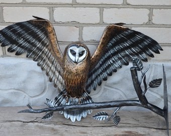 Forged sculpture of an owl on a forged branch