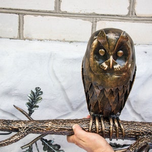 Wrought sconce in the form of an oak branch on which an owl sits with a lantern