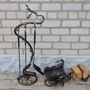 A set of fireplace tools and a stand for firewood, handmade
