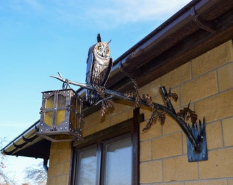 Wrought iron sconce with an owl on a branch