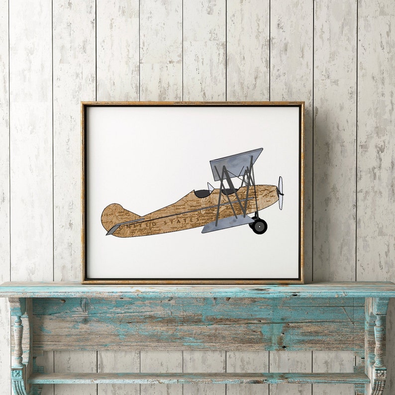 May include: A vintage-style illustration of a brown and gray biplane with the words "United States" printed on the side. The plane is set against a white background.