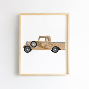 May include: A vintage brown pickup truck with a wooden bed, a white cab, and blue wheels. The truck is on a white background.