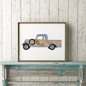 May include: A framed print of a vintage pickup truck with a light blue body and a brown wooden bed. The truck is on a white background.