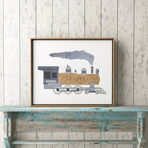May include: A framed print of a blue train engine with a brown and white map pattern on the side. The train is labeled "Explorer" and "Australia". The train is emitting a blue smoke plume.