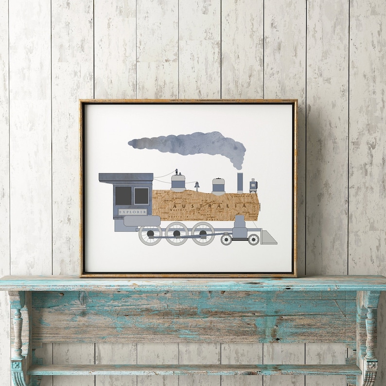 May include: A framed print of a blue train engine with a brown and white map pattern on the side. The train is labeled "Explorer" and "Australia". The train is emitting a blue smoke plume.