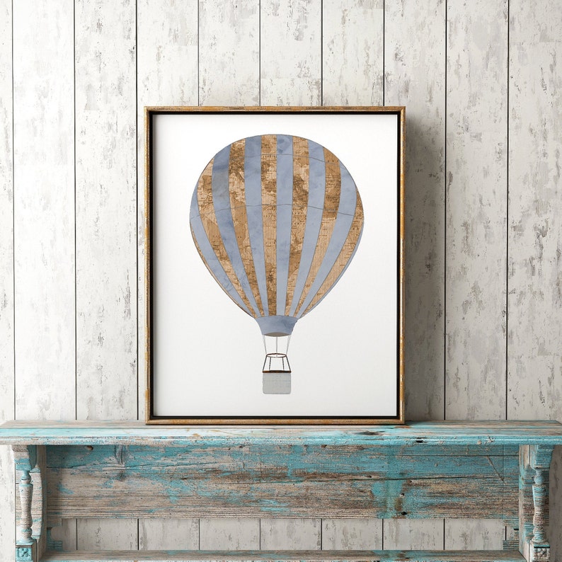 May include: A framed print of a blue and brown hot air balloon with stripes. The balloon is against a white background.